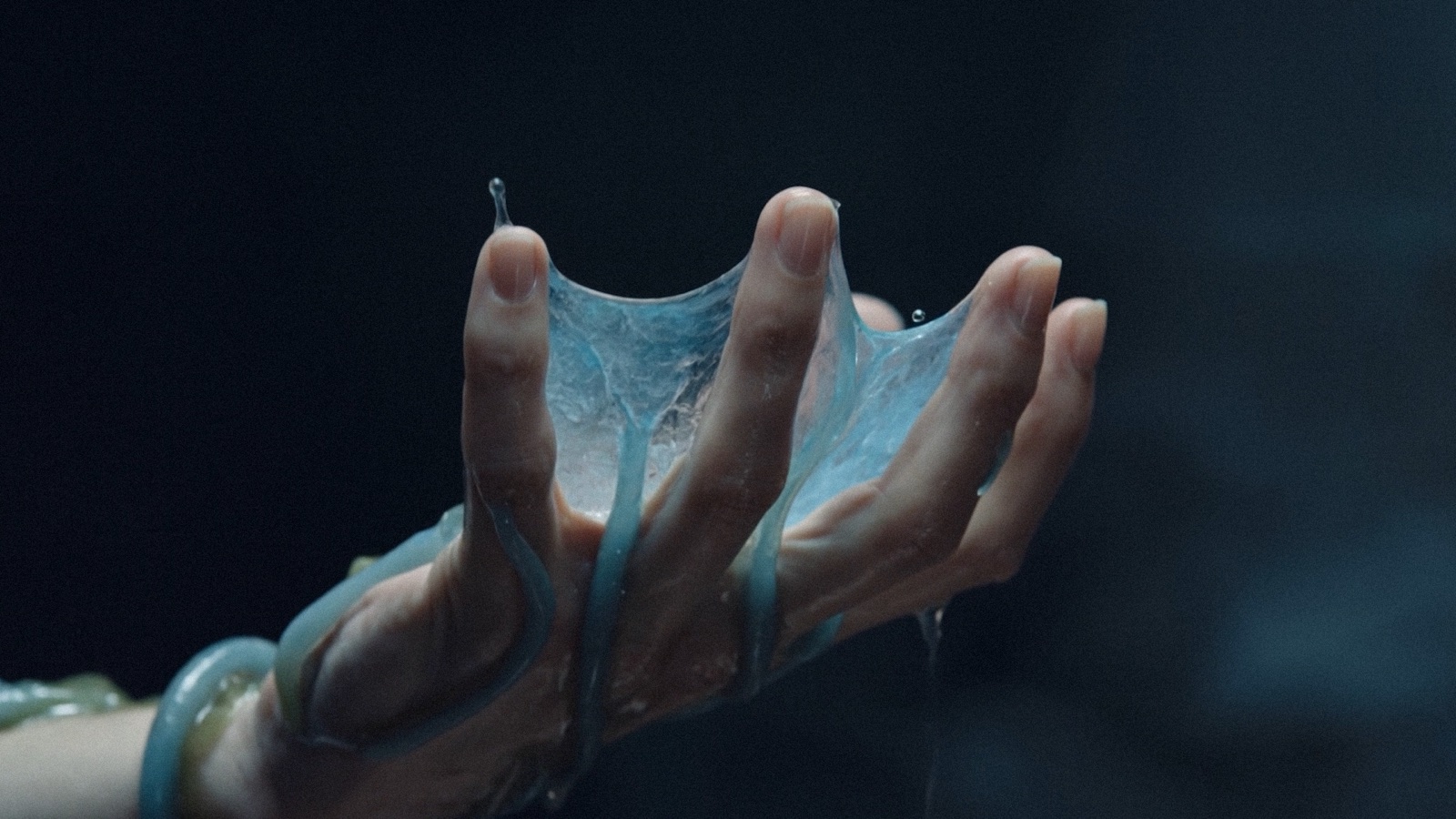 A hand stretching a translucent shed membrane